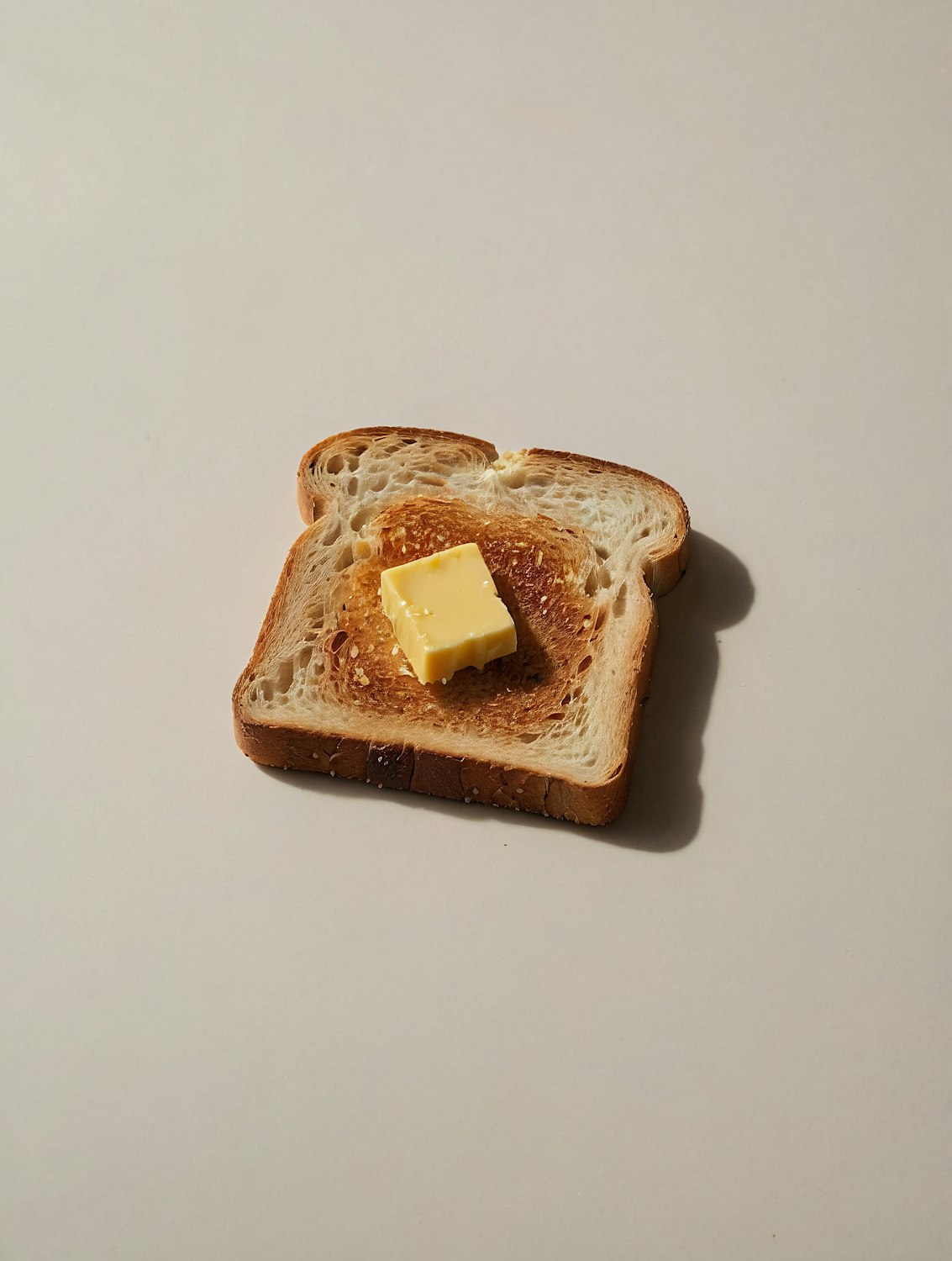 Golden toast with a cube of butter melting on top